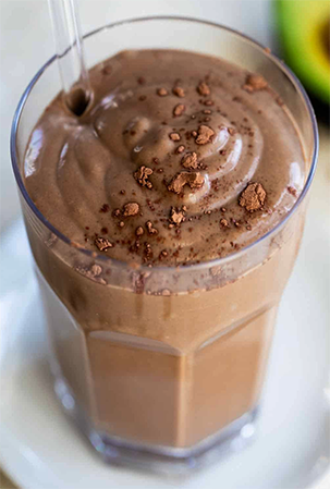 pure chocolate smoothie in a glass topped with chocolate shavings