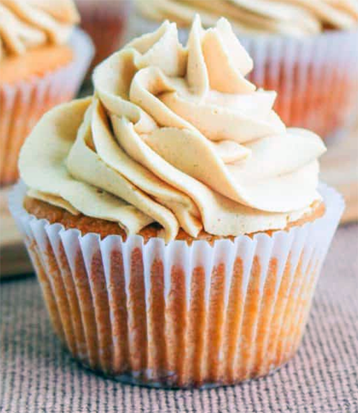 rapeseed and peanut butter cupcake with cream cheese and peanut butter icing in a paper case