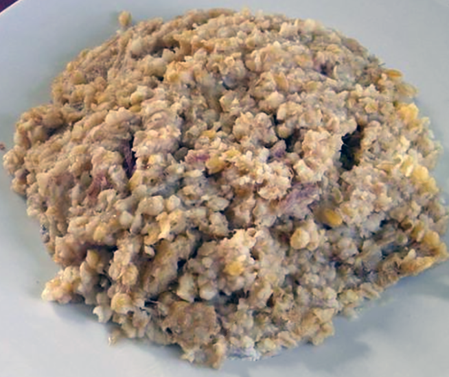 Cypriot ressi, wheat pilaff with lamb and lamb fat mounded on a white plate