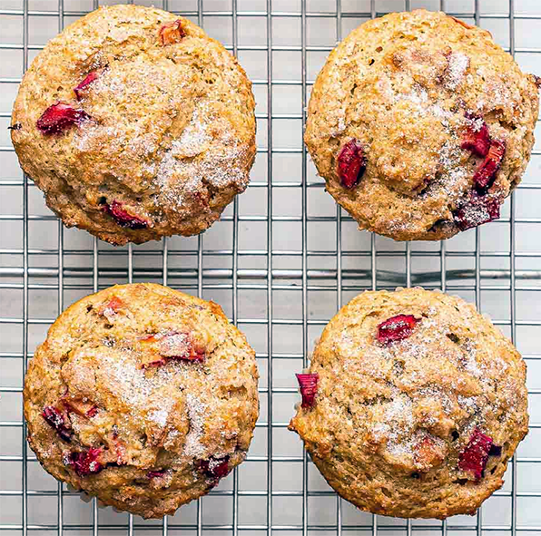 four rhubarb pecan muffins cooling on a wire rack