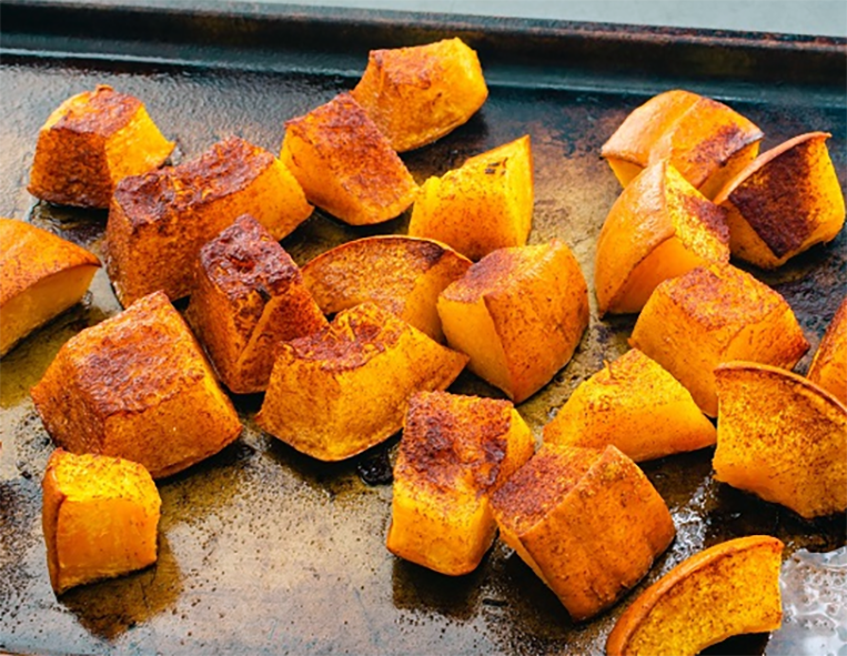 oven roasted pumpkin pieces on a baking tray