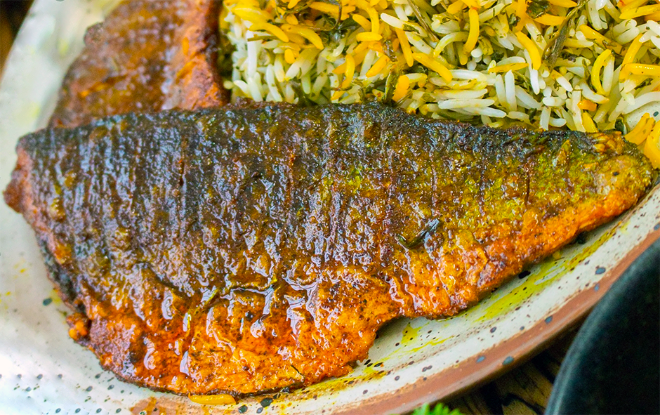 fillet of fish served with saffron hand herb rice on a plate