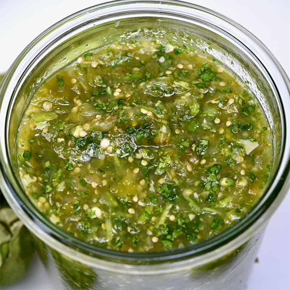 green tomato salsa in a glass jar