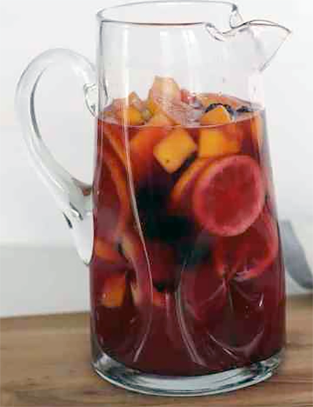 virgin sangria cocktail served with sliced fruit in a jug</atl>