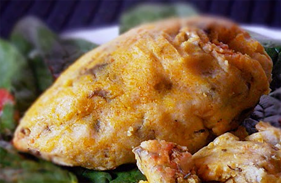 steamed maize sapala served on a bed of greens