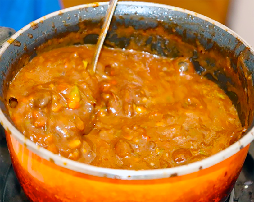 spicy tamarind sauce cooking in a pan