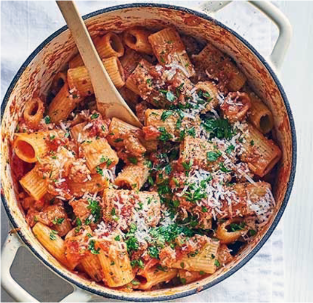 sausage ragu with rigatoni pasta in a cast iron casserole (Dutch oven)