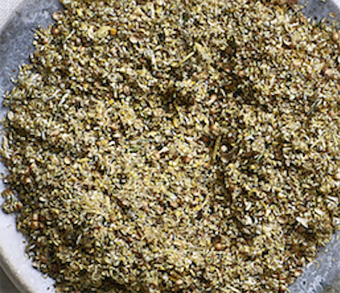 blend of sea arrowgrass and stinging nettle seeds with chamomile flowers on a plate