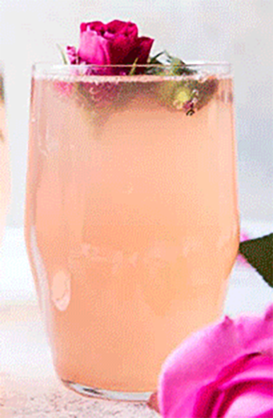 sharab al ward, rose water drink in a glass garnished with a rose flower