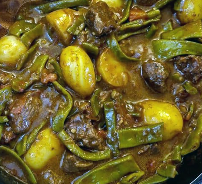 green bean bredie with lamb in a casserole dish