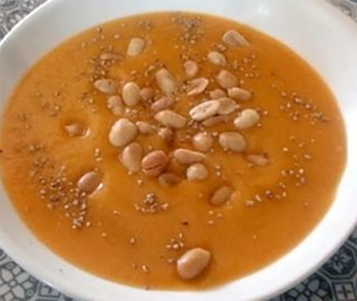 Senegalese peanut soup served in a soup bowl with a garnish of peanuts
