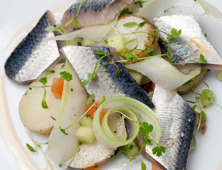 soused herrings served with potatoes and onions