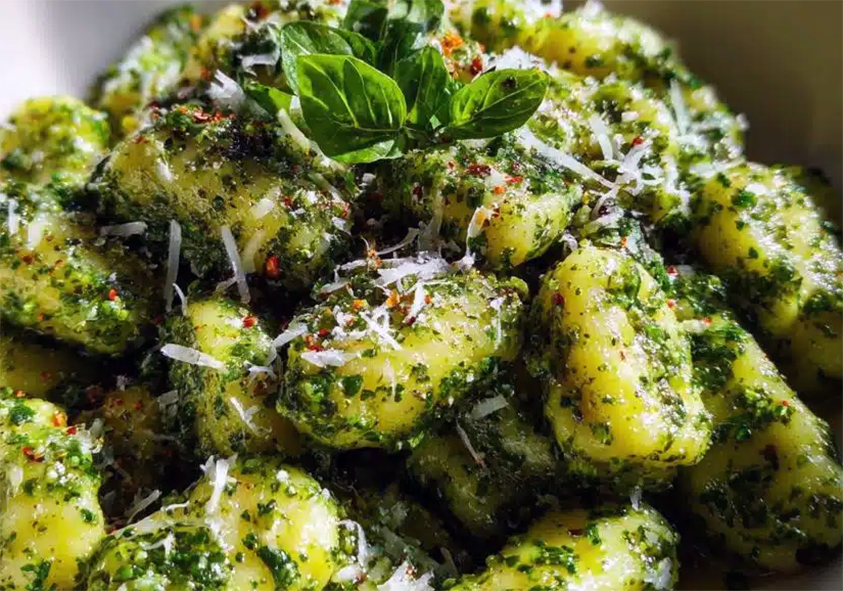 spinach, wild greens and cheese gnocchi in a bowl