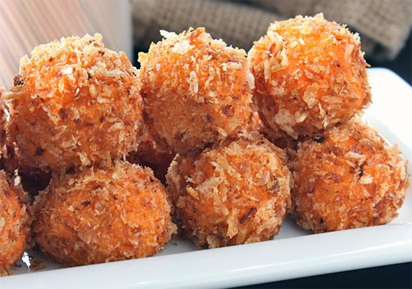 sweet potato stuffing balls arranged on a rectangular plate