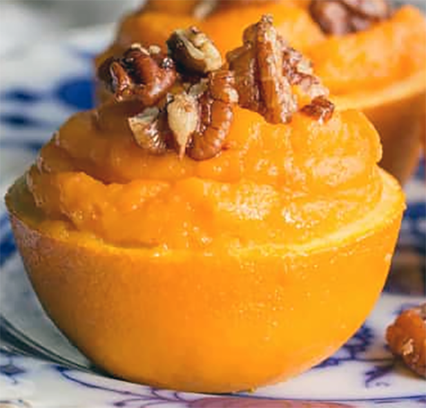 sweet potato filled orange garnished with walnuts