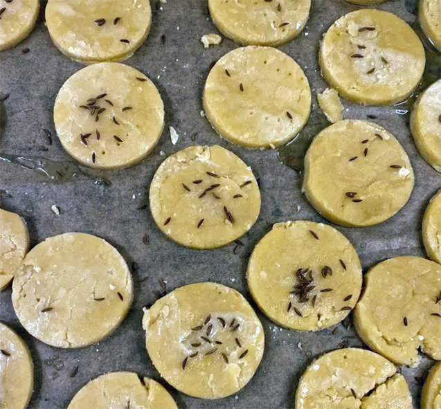 raw caraway topped Tonbridge biscuits on a baking tray