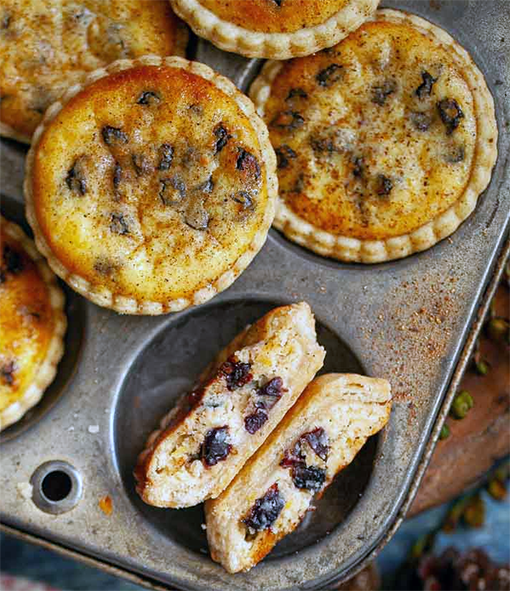towcaster cheesecakes on a baking tin with one split in half to reveal the filling