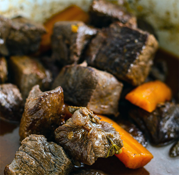 braised venison with carrots in an enamelled casserole