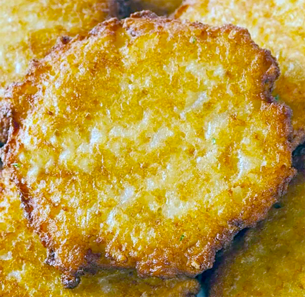 air fried mashed potato cake presented on a pile of other potato cakes
