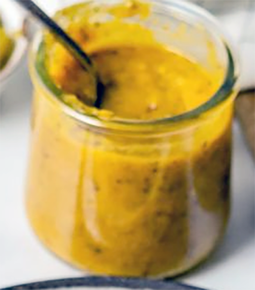 amba sauce in a jam jar with a spoon