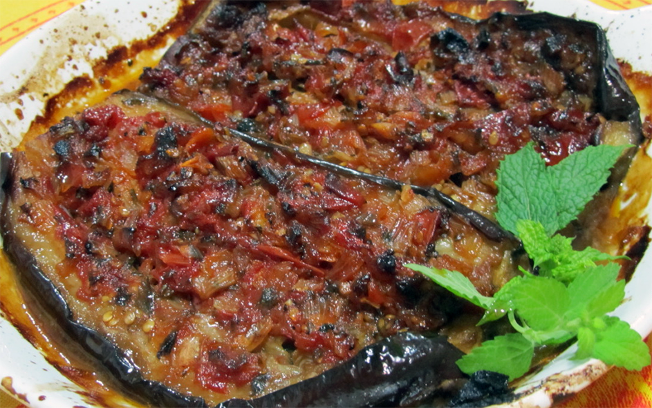 Armenian imam baylidi in a baking dish with a garnish of mint sprigs