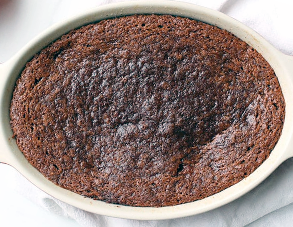 persimmon pudding in an oval baking dish