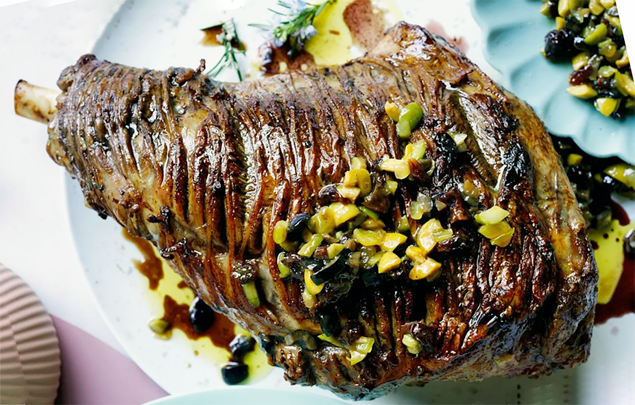 scored, barbecued leg of lamb served topped with olive and raisin compote