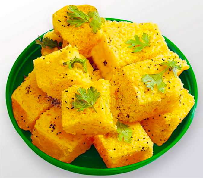 cubes of dhokla piled in a green blow