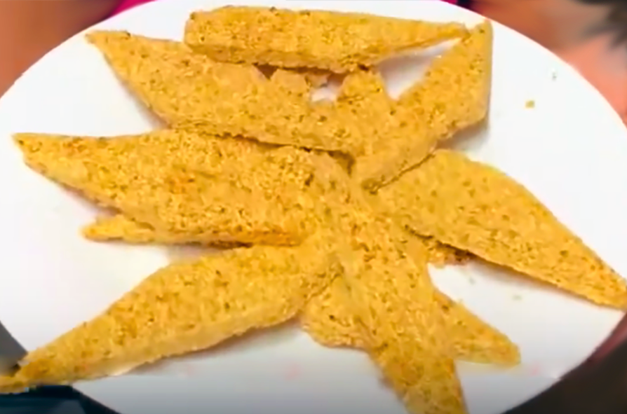 diamonds of benne cake (sesame seed wafers) arranged on a white plate