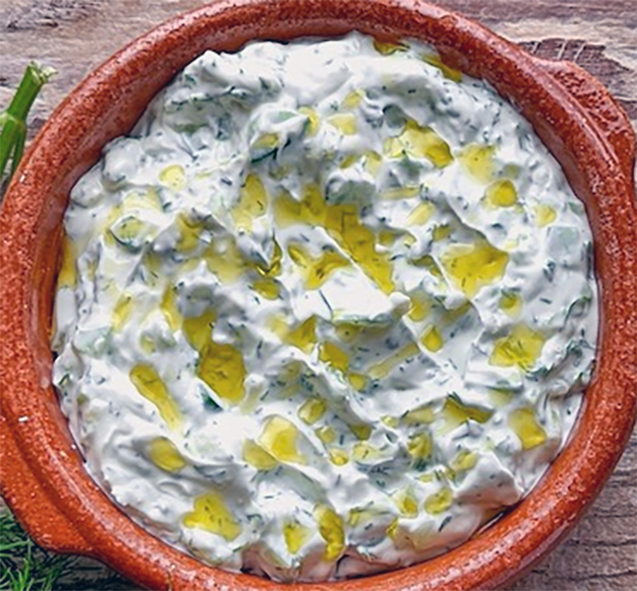 Turkish Cypriot cakic, yoghurt, cucumber and mint dip drizzled with olive oil in an earthenware bowl