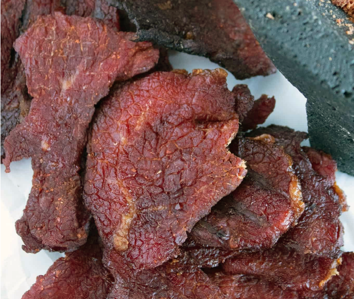 pieces of carne seca shown next to a mortar