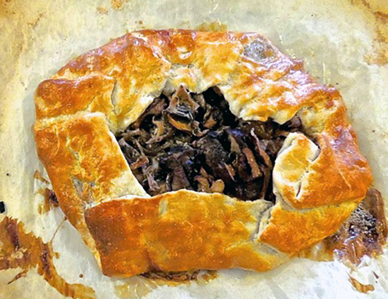 chanterelle-filled galette on a piece of baking parchment