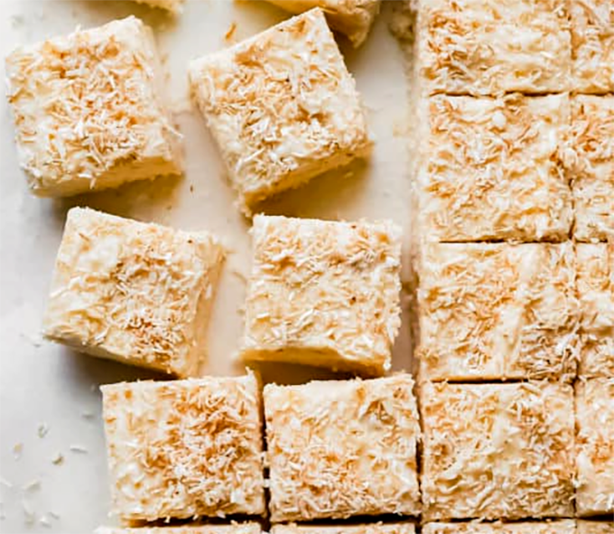 coconut and apricot fudge cake divided into square pieces