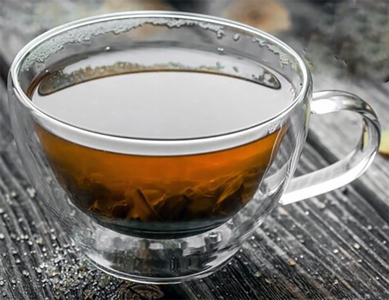 costus root tea in a glass cup
