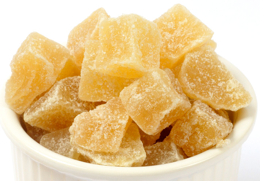 Crystallized ginger piled in a white ramekin