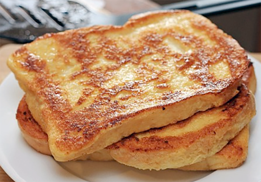 three slices of eggy bread arranged on a plate