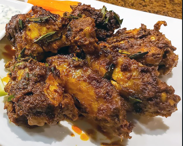 Ethiopian-spiced chicken wings piled on a plate