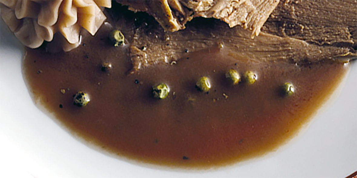 chevreuil sauce served on a plate beneath mushroom mousse and slices of beef
