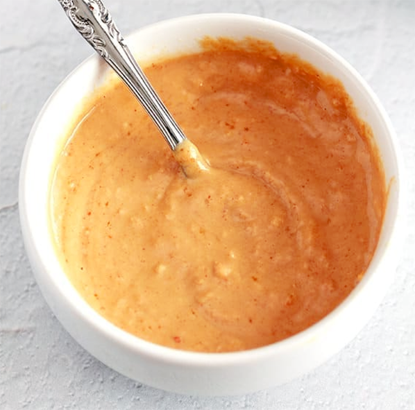 mustard horseradish sauce with redcurrant jelly in a ramekin with a spoon