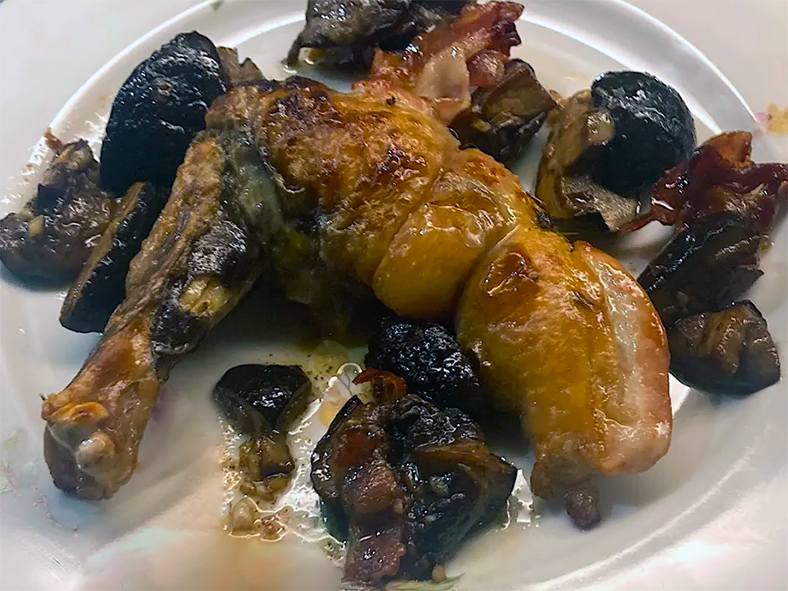 roasted supreme of guineafowl on a plate surrounded by fried bay boletes.