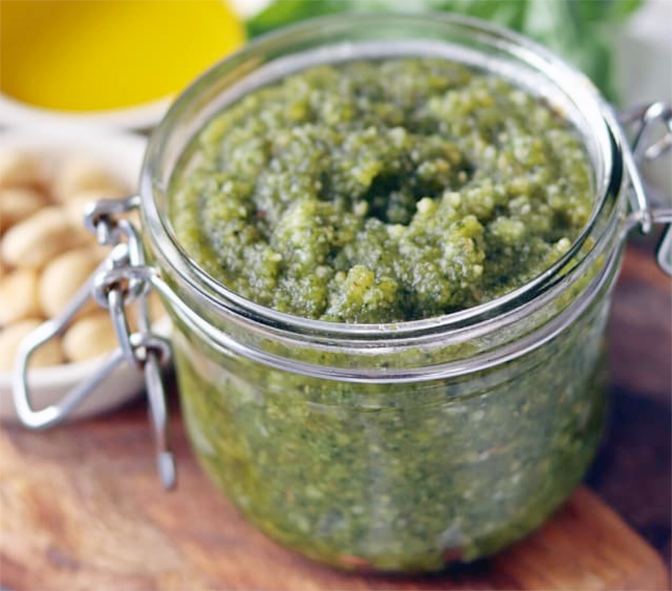 hazelnut and wild greens pesto in a clip-top jar