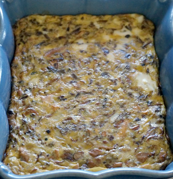 hedgehog mushroom and sorrel frittata in a blue baking dish