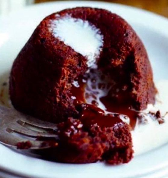 hot chocolate fondant in a bowl with cream opened with a fork