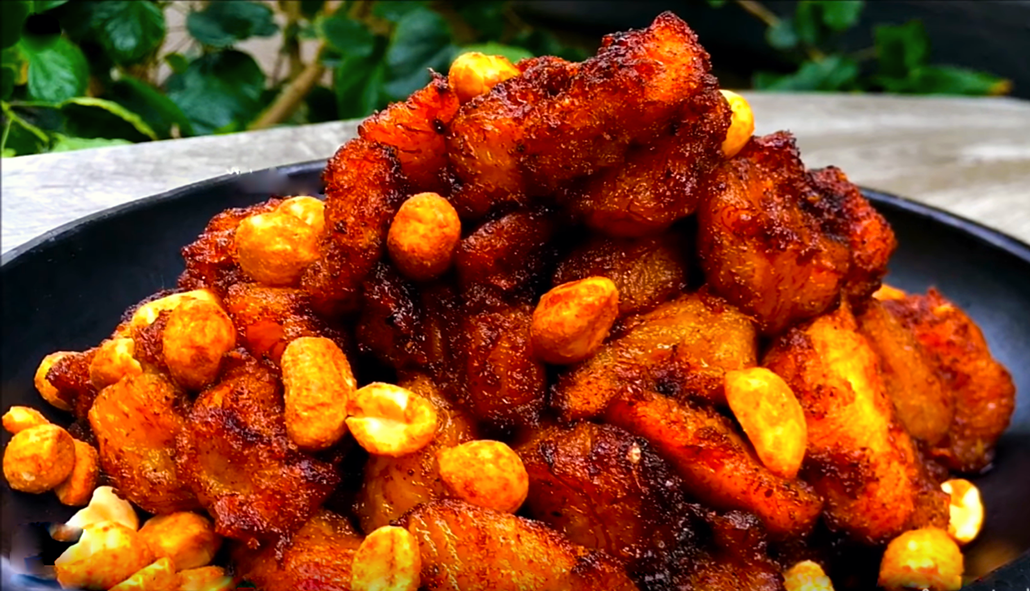 plantains and peanuts with chillies and ginger fried in red oil and piled on a plate