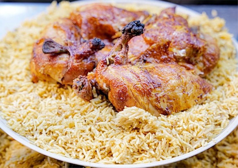khuzi, spiced lamb pieces served on a bed of the rice with which it's cooked