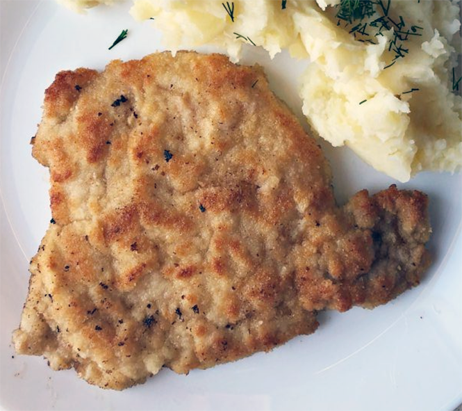 Kotlet Schabowy, Polish breaded pork cutlet on a plate with mashed potatoes
