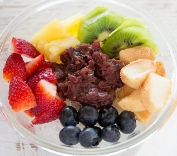 shaved water ice served topped with fruit and sweet red bean paste