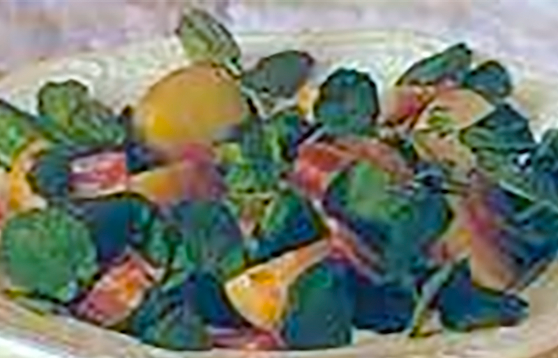 warm salad of potato, watercress and bacon on a plate