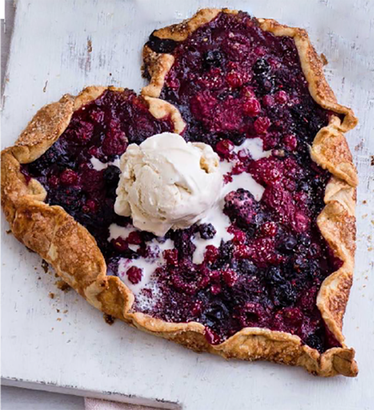 heart shaped red berry galette served with a scoop of ice cream