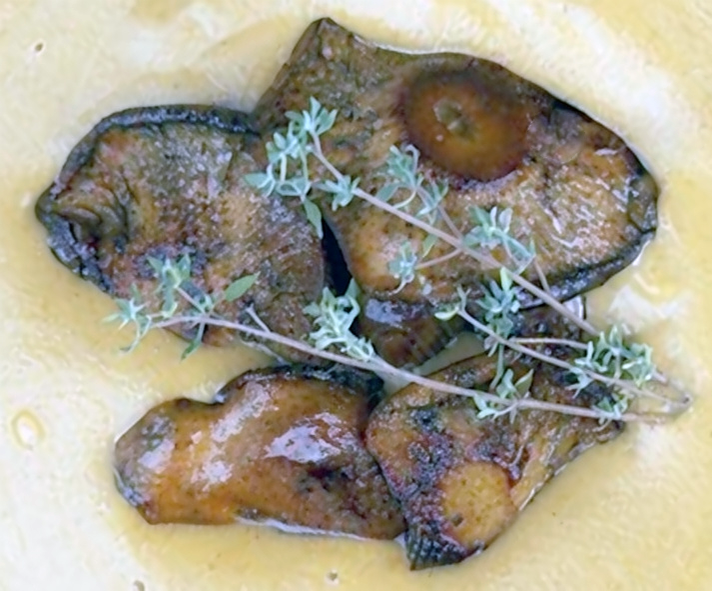 saffron milk caps piled in the middle of a cream sauce in which they were cooked